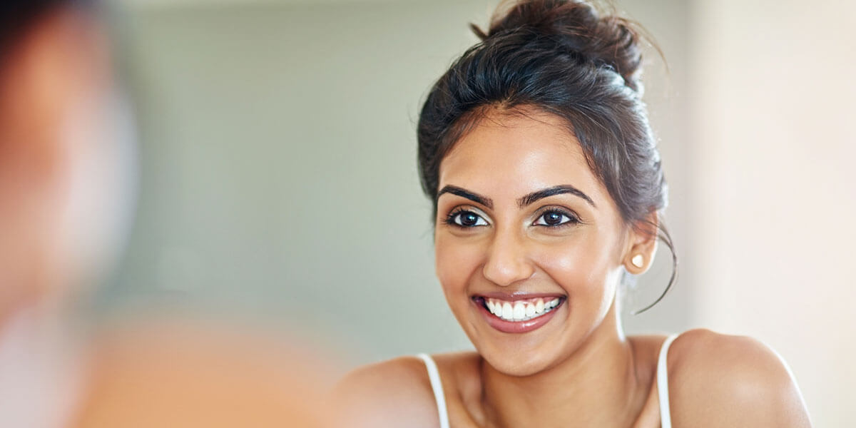 Woman flossing her teeth